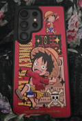 Red One Piece Luffy phone case with straw-hat character artwork and wanted-poster details